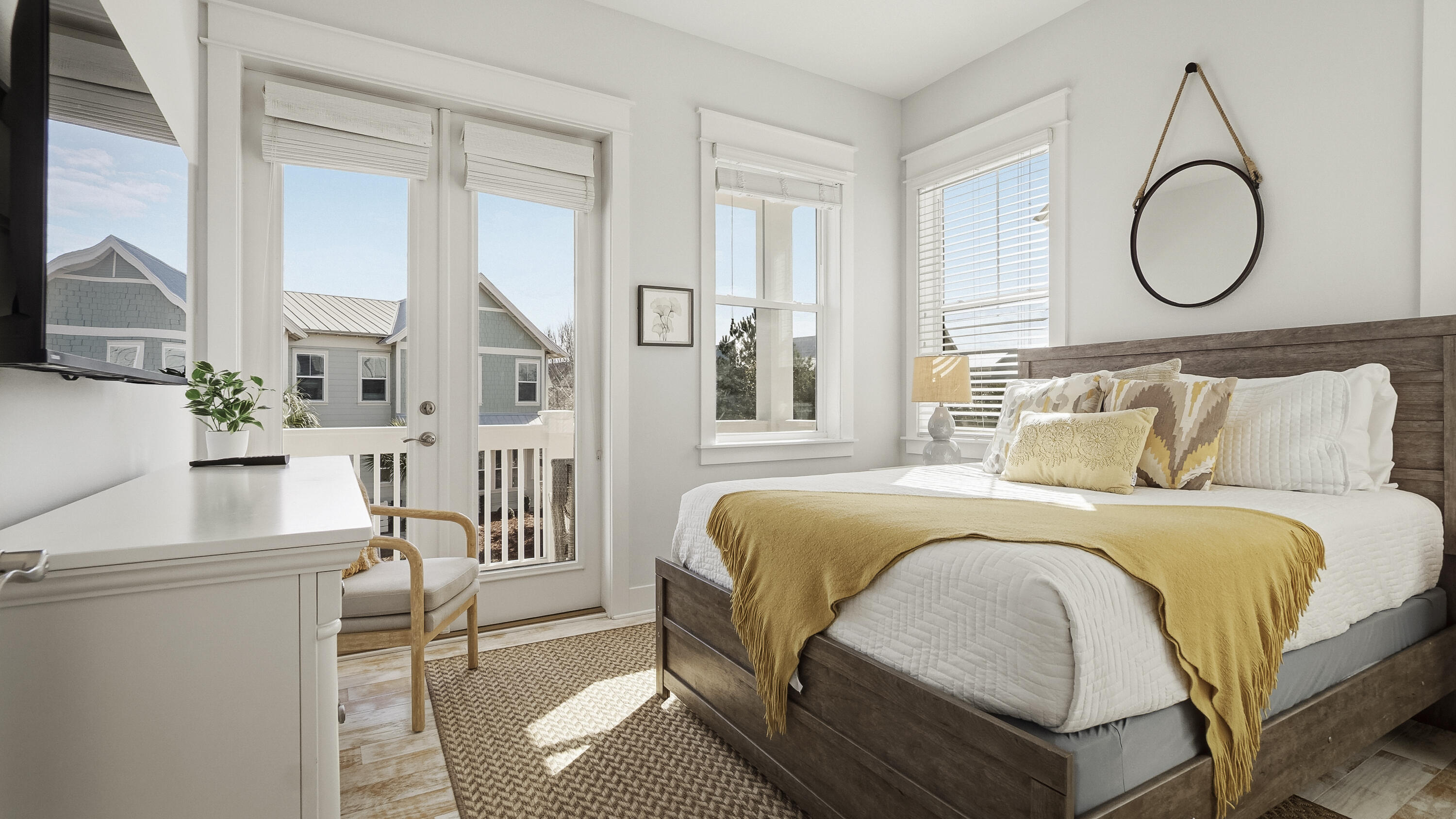 197 Milestone Drive, Unit C Inlet Beach, FL 32461 - Photo 33 of 72 a bedroom with a bed a mirror and a large window