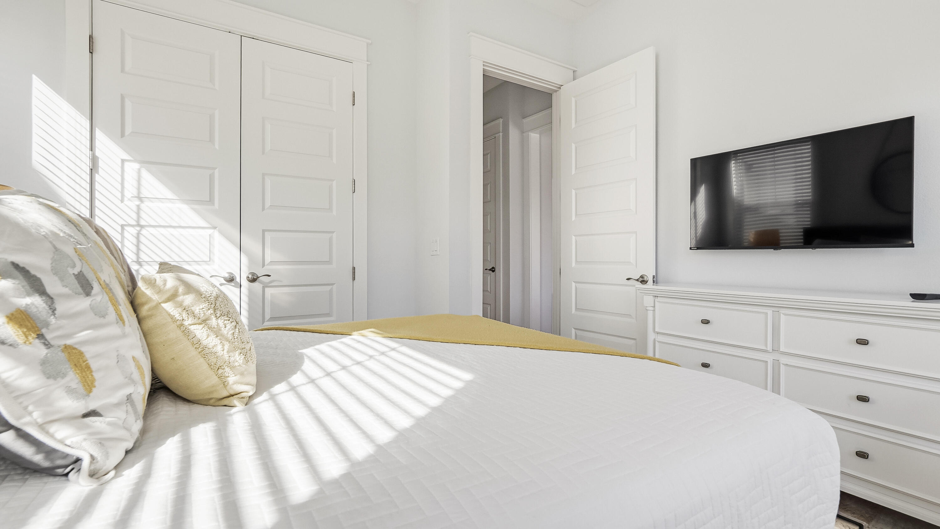 197 Milestone Drive, Unit C Inlet Beach, FL 32461 - Photo 34 of 72 a bedroom with a bed and a flat screen tv in it