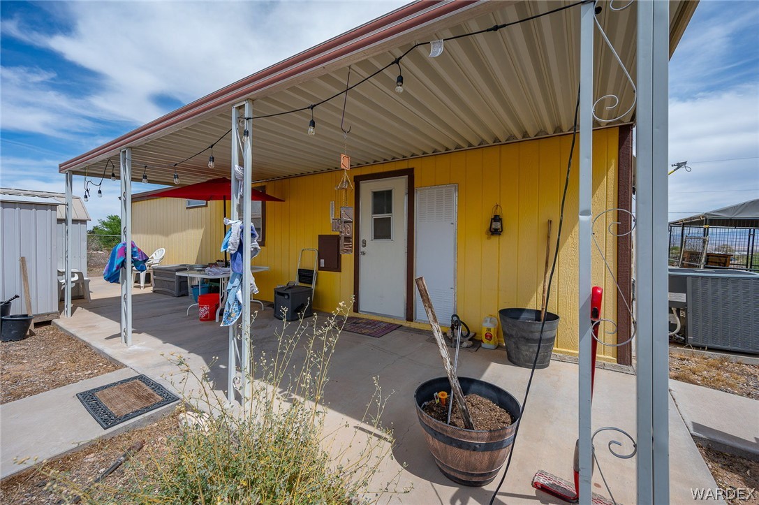 2465 Egar Road Golden Valley, AZ 86413 - Photo 41 of 98 The property features an exterior with yellow siding and a covered patio area