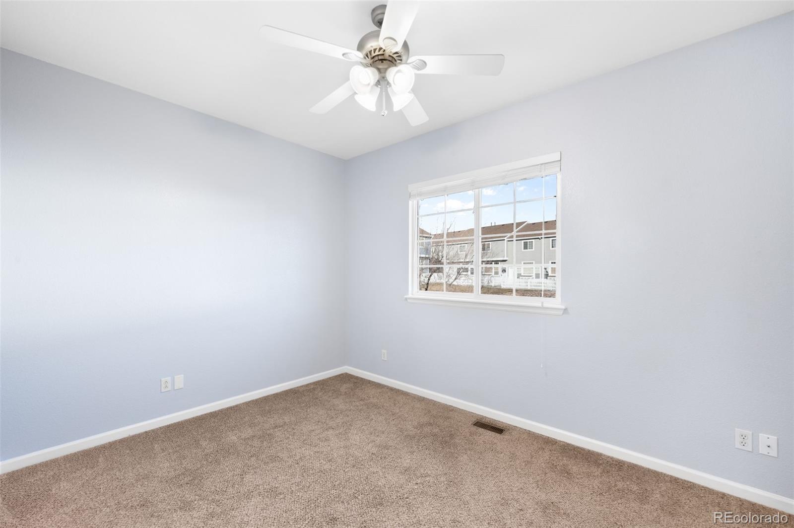 8199 Welby Road, Unit 3102 Denver, CO 80229 - Photo 11 of 18 an empty room with a window and a fan