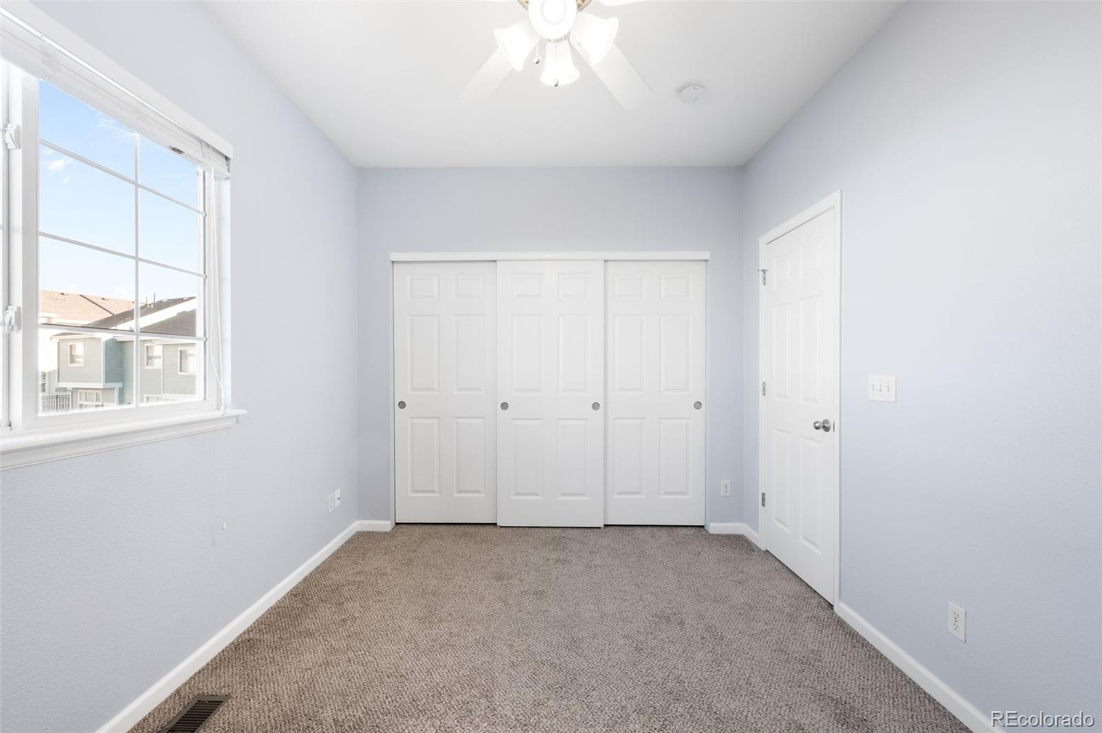 8199 Welby Road, Unit 3102 Denver, CO 80229 - Photo 12 of 18 a view of an empty room with a window