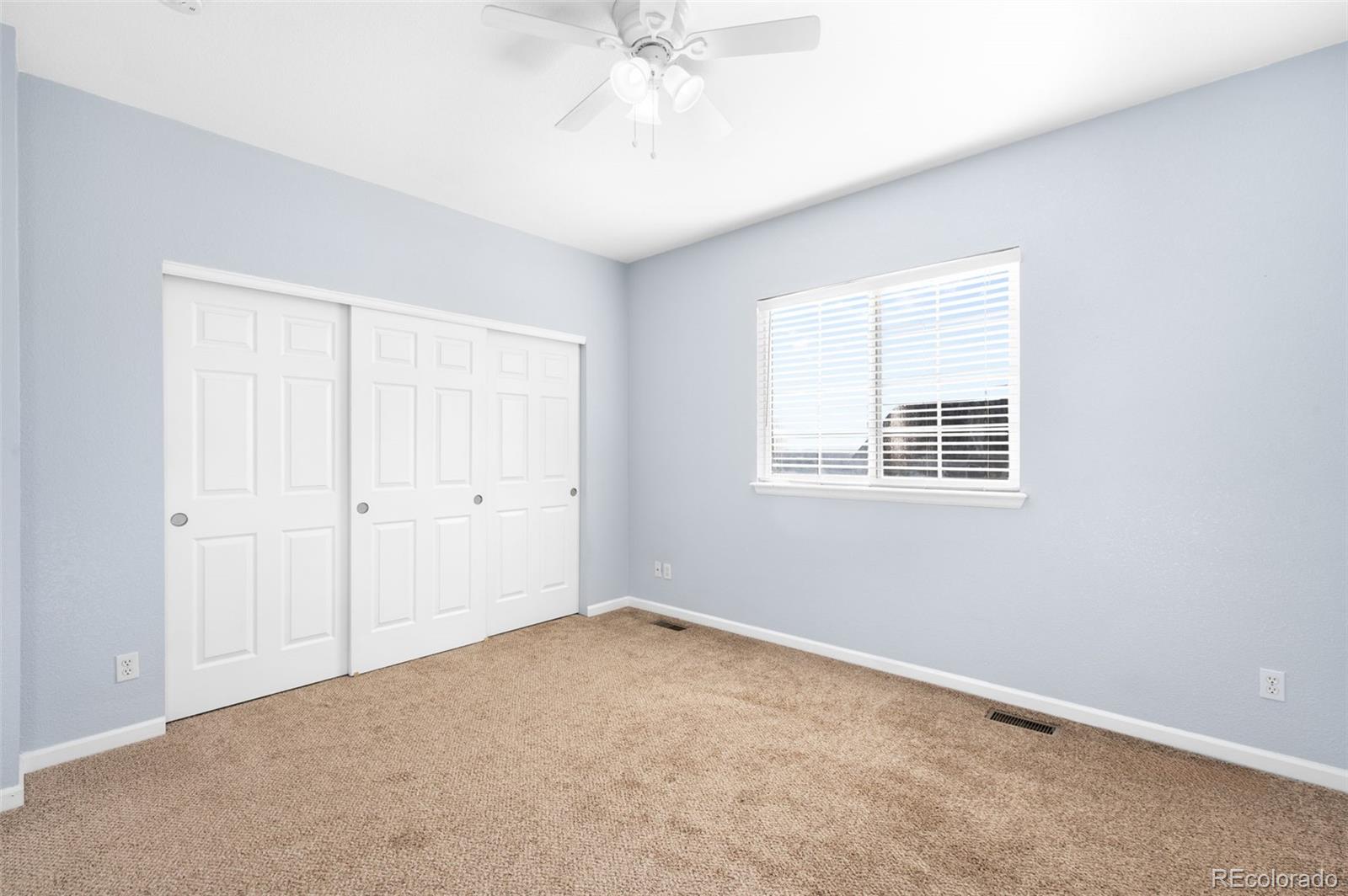 8199 Welby Road, Unit 3102 Denver, CO 80229 - Photo 14 of 18 a view of an empty room with a window