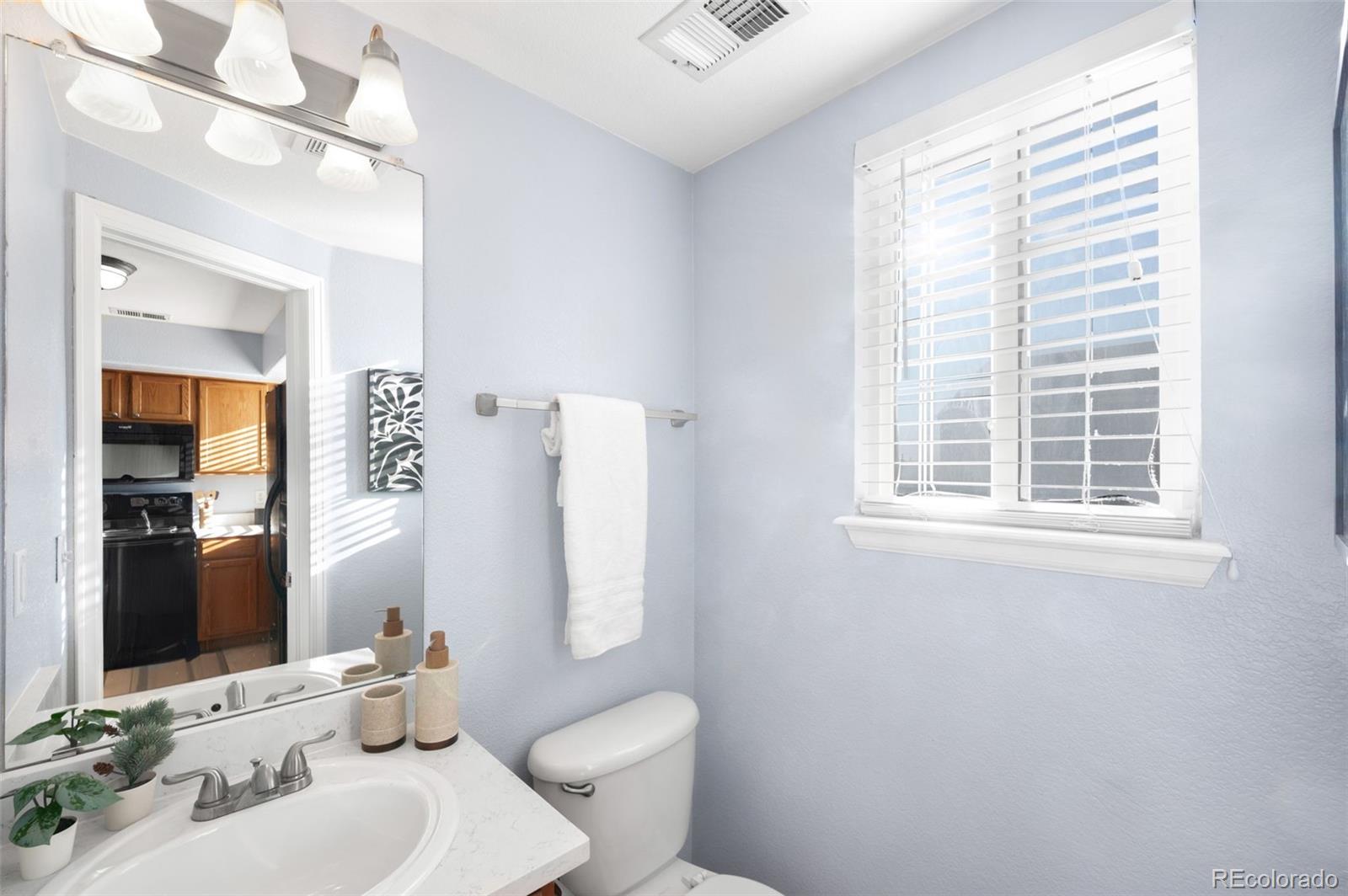 8199 Welby Road, Unit 3102 Denver, CO 80229 - Photo 17 of 18 a bathroom with a sink and a mirror
