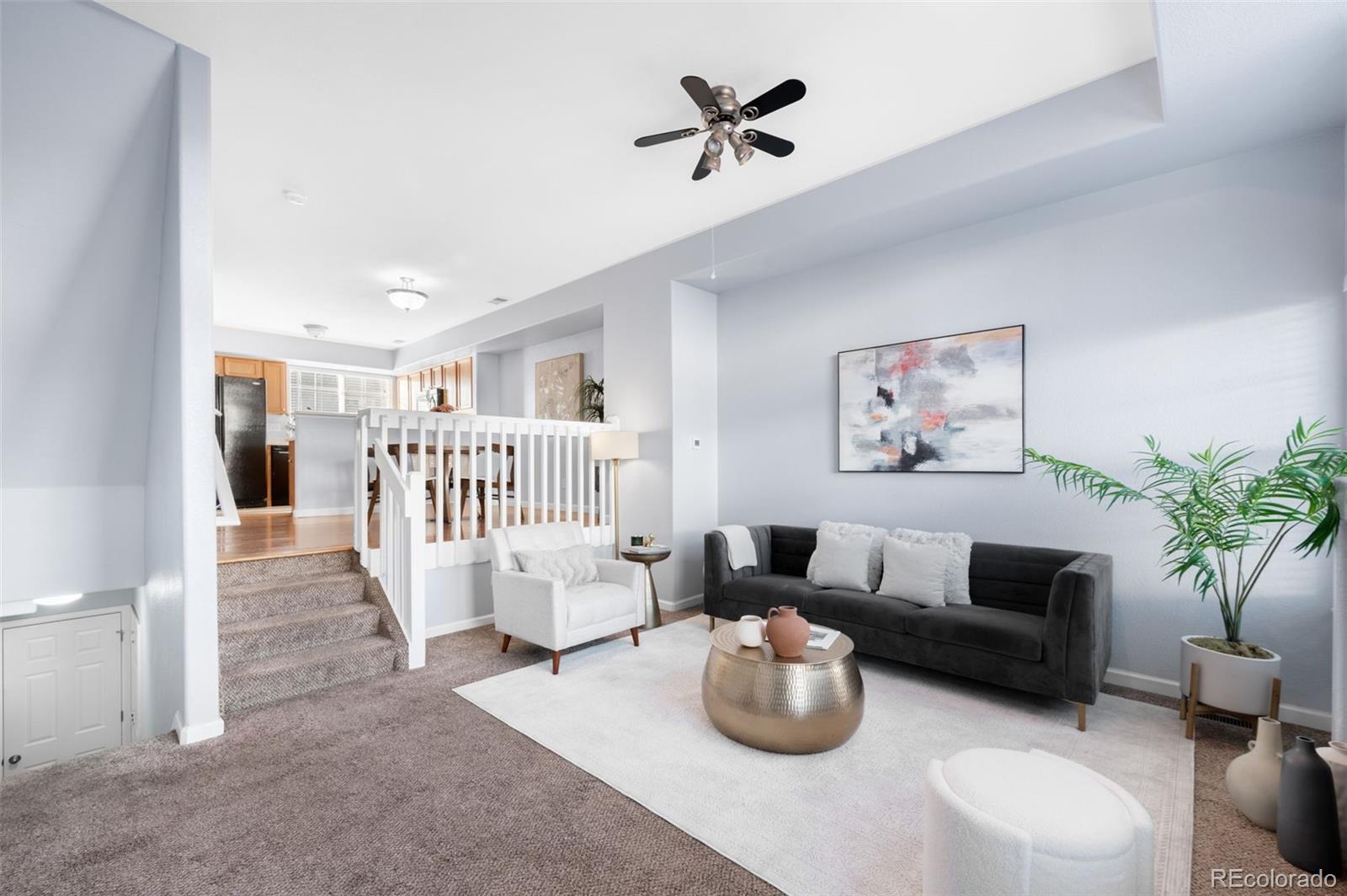 8199 Welby Road, Unit 3102 Denver, CO 80229 - Photo 2 of 18 a living room with furniture and a wooden floor