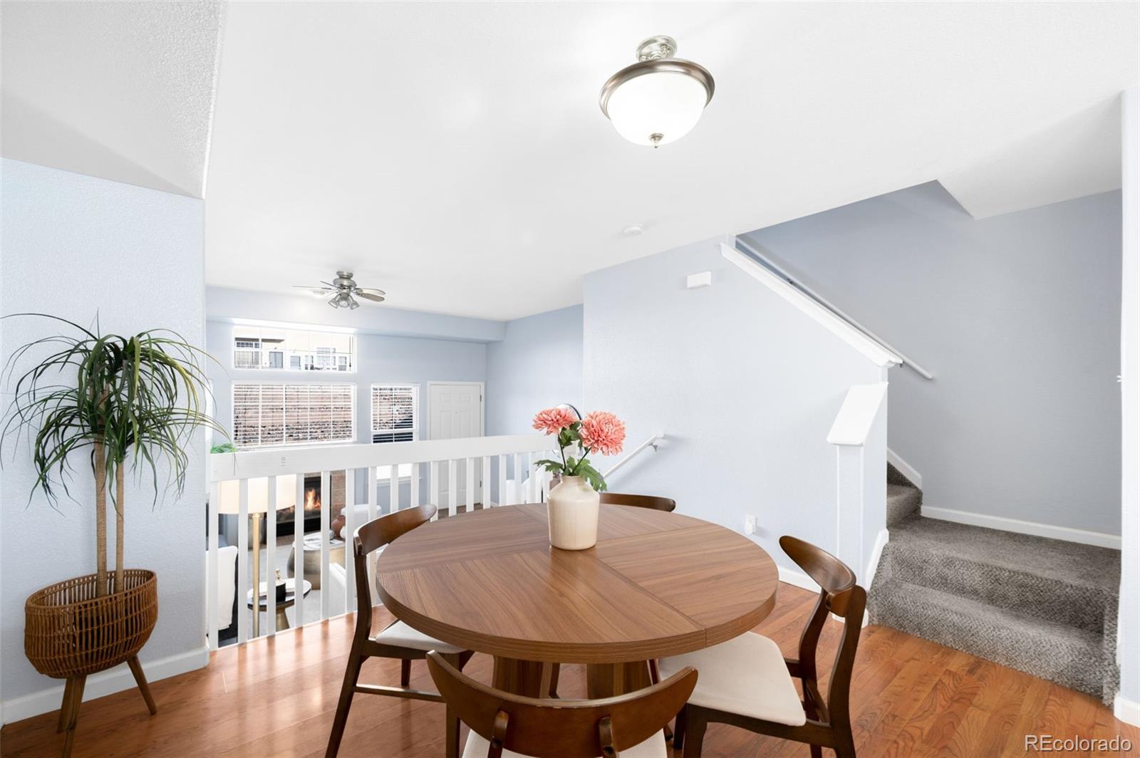 8199 Welby Road, Unit 3102 Denver, CO 80229 - Photo 5 of 18 a view of a dining room with furniture and wooden floor