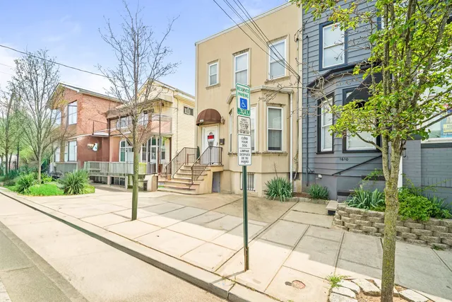 a view of a brick building next to a road