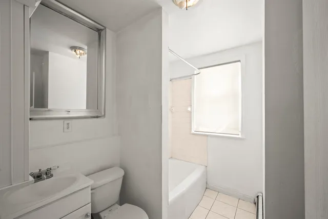 a bathroom with a toilet a sink and bath tub