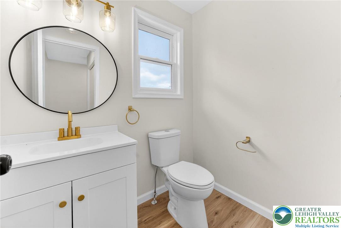 5693 Neola Road Stroudsburg, PA 18360 - Photo 15 of 30 a bathroom with a toilet a sink and a mirror