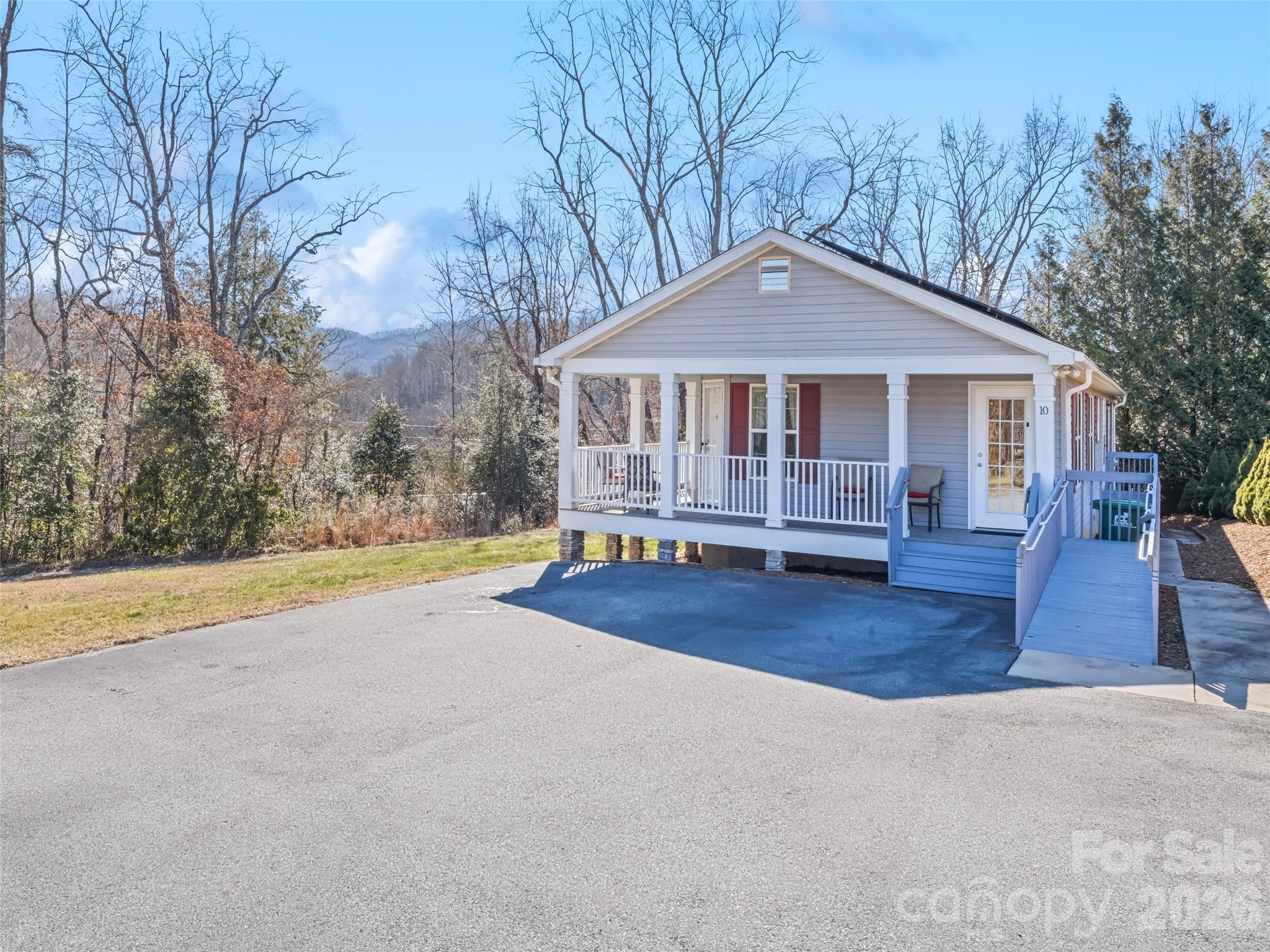 10 Enochs Way Fletcher, NC 28732 - Photo 1 of 24 a view of a house with large trees and wooden fence