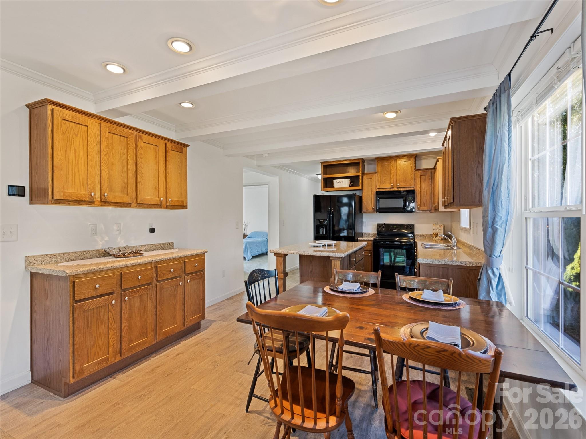 10 Enochs Way Fletcher, NC 28732 - Photo 11 of 24 a open kitchen with stainless steel appliances granite countertop a stove a sink a refrigerator dining table and chairs