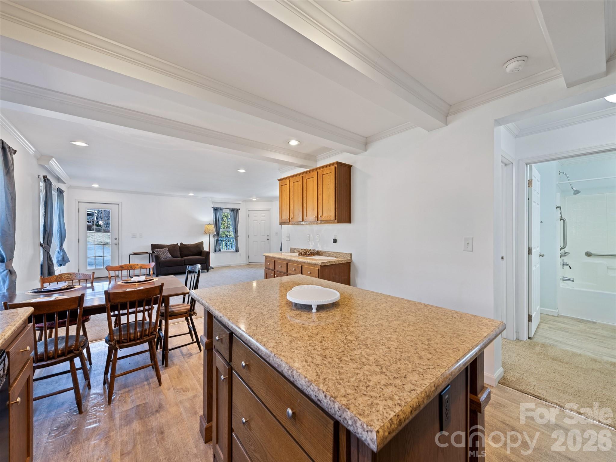 10 Enochs Way Fletcher, NC 28732 - Photo 12 of 24 a kitchen with granite countertop kitchen island stainless steel appliances sink dining table and chairs