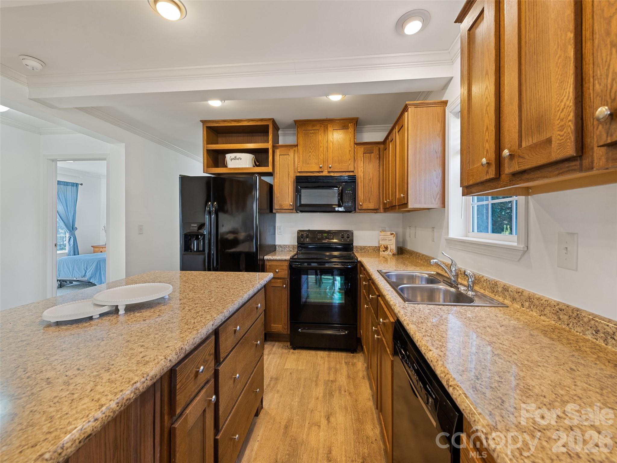 10 Enochs Way Fletcher, NC 28732 - Photo 14 of 24 a kitchen with granite countertop a sink stove and refrigerator