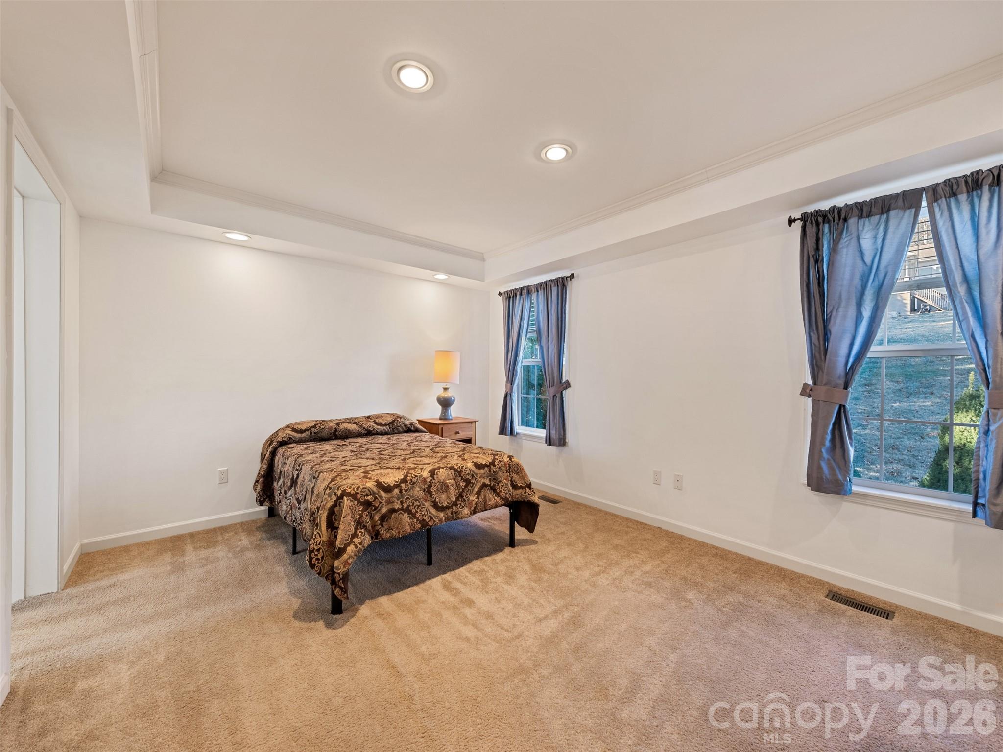 10 Enochs Way Fletcher, NC 28732 - Photo 15 of 24 a bed sitting in a room next to a window