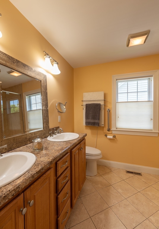 20 Bridge Road, Unit 8 Northampton, MA 01062 - Photo 19 of 32 a bathroom with a granite countertop sink toilet and mirror