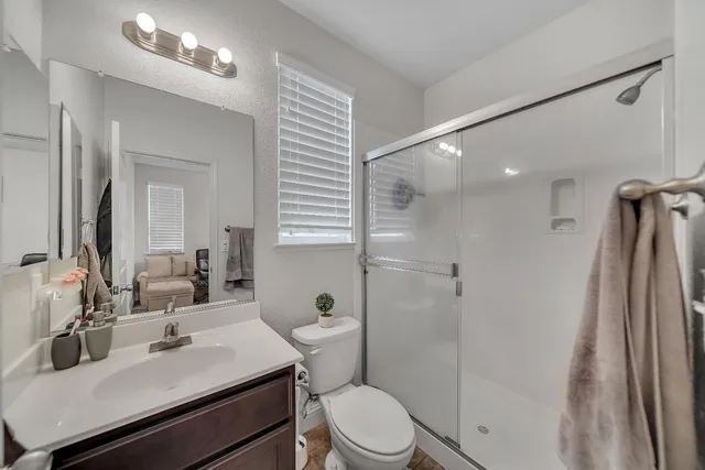 a view of a hallway with wooden floor fireplace and living room