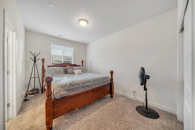 a view of a hallway with closet and a bathroom