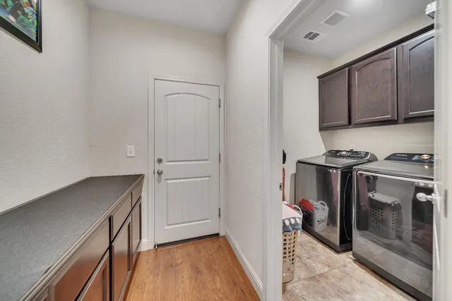 a bedroom with a bed chandelier and a window
