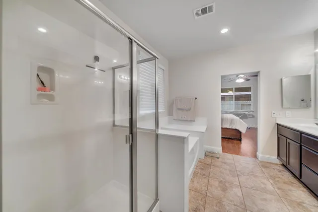 a living room with furniture a flat screen tv and kitchen view