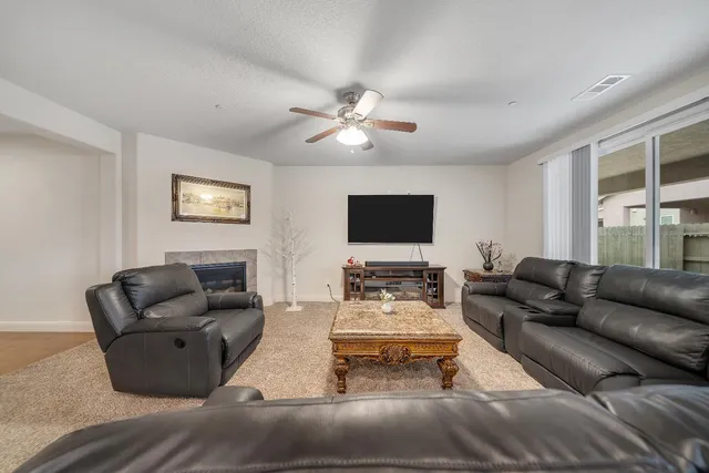 a living room with furniture kitchen view and a fireplace