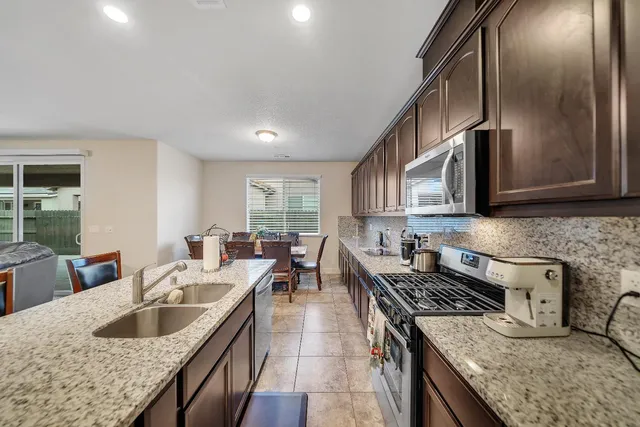 a view of a dining room with furniture and a kitchen