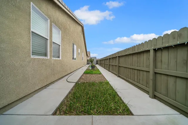 a view of front a house with a yard and garage