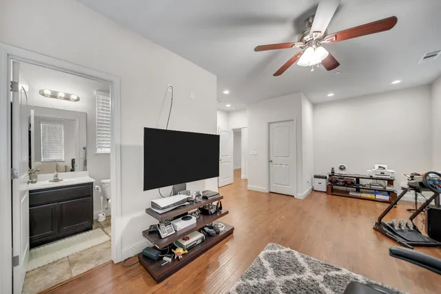 a bathroom with a sink a toilet a mirror and shower