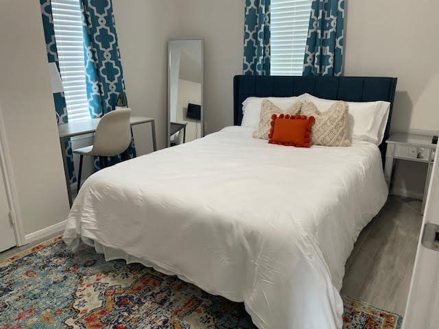 4903 Noble Street, Unit 1 Houston, TX 77020 - Photo 12 of 16 a large bed sitting in a bedroom next to a window and chair