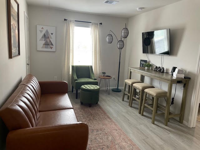 4903 Noble Street, Unit 1 Houston, TX 77020 - Photo 4 of 16 a living room with furniture a flat screen tv and a window