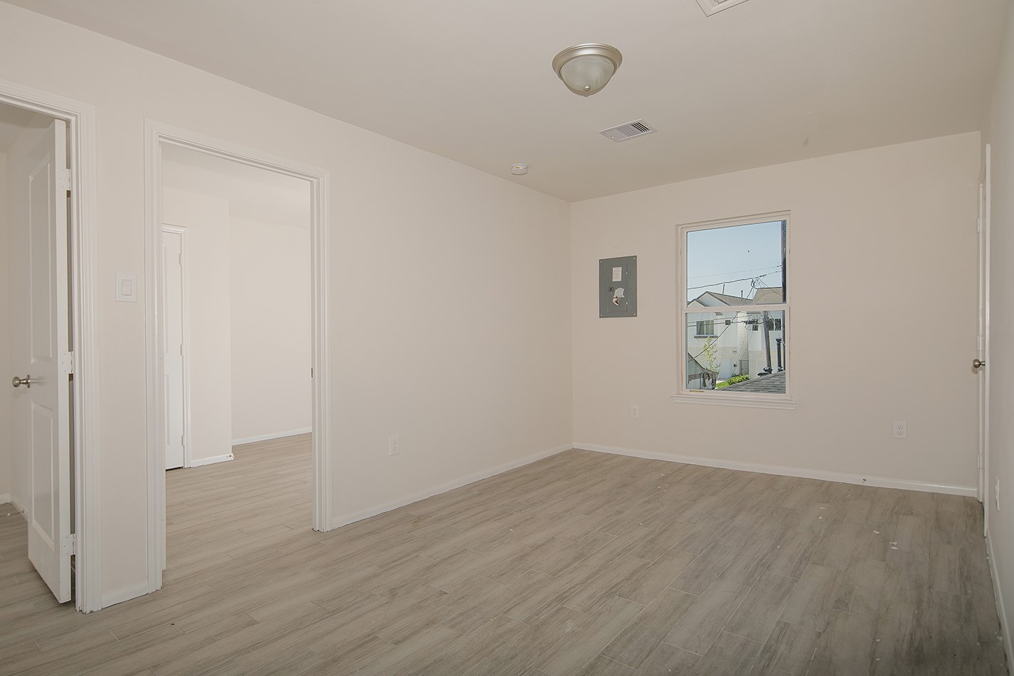 4903 Noble Street, Unit 1 Houston, TX 77020 - Photo 6 of 16 an empty room with wooden floor and windows