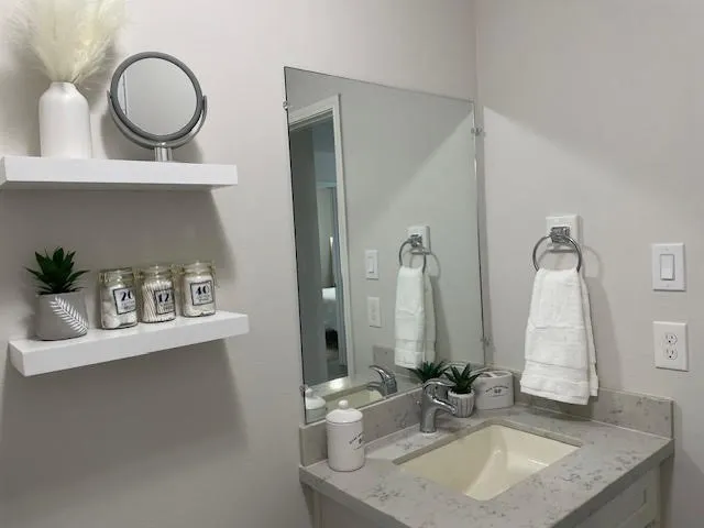a bathroom with a sink and a mirror