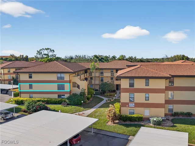a front view of a house with a yard and potted plants