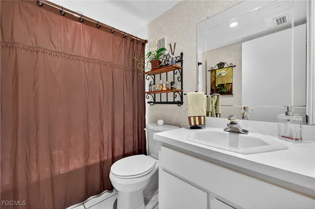 a utility room with dryer washer and shoe rack