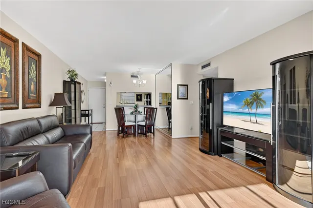 a living room with furniture and kitchen view