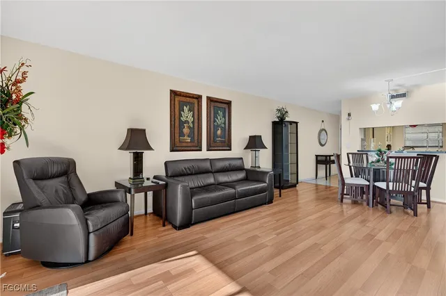 a living room with furniture wooden floor and a table