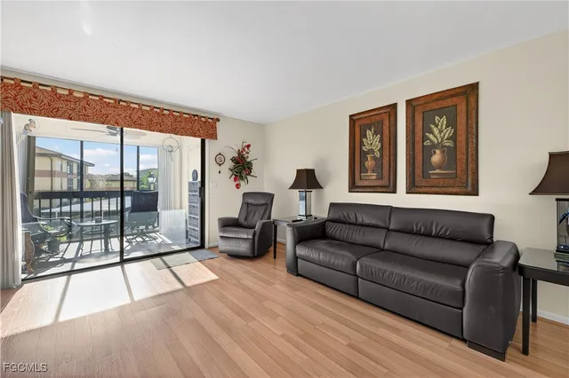 a living room with furniture and large windows