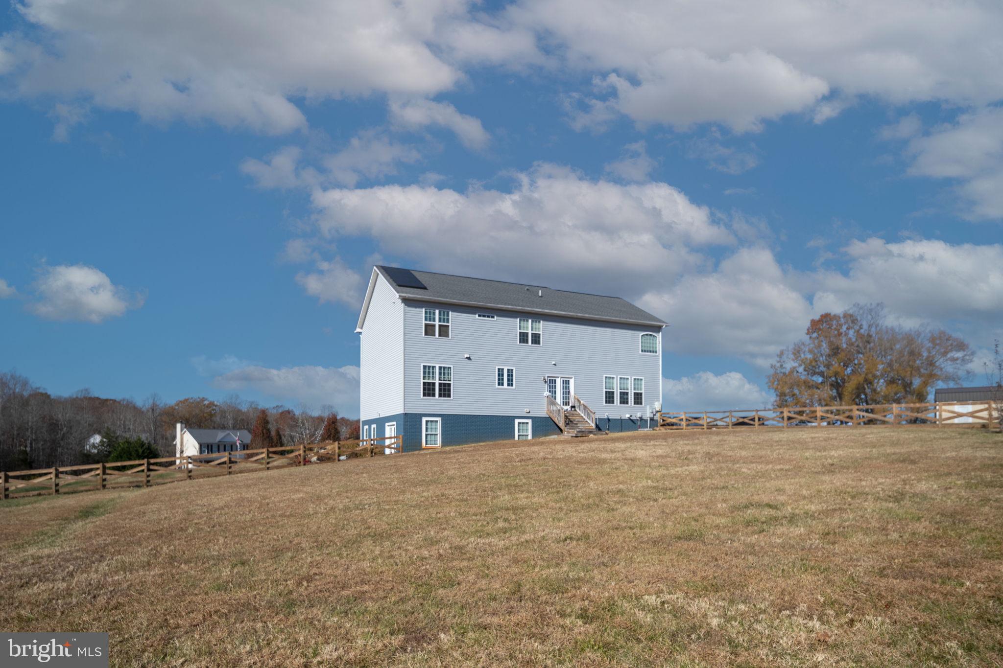 9590 Blackbird Loop Culpeper, VA 22701 - Photo 13 of 76 a large building with trees in front of it