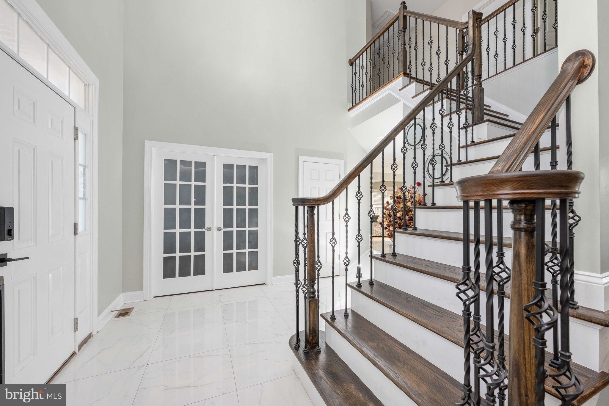 9590 Blackbird Loop Culpeper, VA 22701 - Photo 26 of 76 a view of staircase with lots of frames and a window