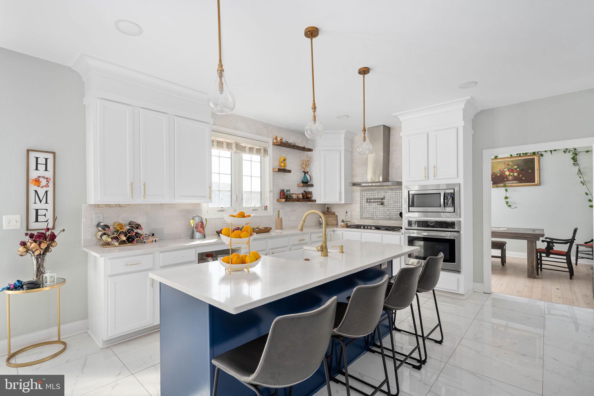 9590 Blackbird Loop Culpeper, VA 22701 - Photo 33 of 76 a kitchen with a sink a stove a dining table and chairs