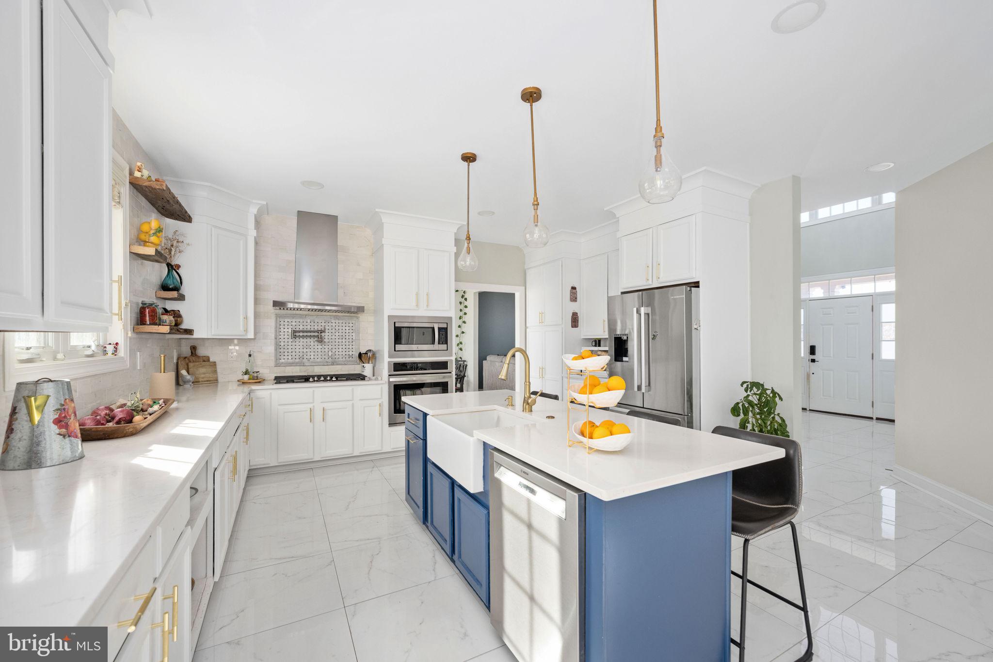 9590 Blackbird Loop Culpeper, VA 22701 - Photo 34 of 76 a view of a kitchen with kitchen island a stove a refrigerator a sink dishwasher with a dining table and chairs