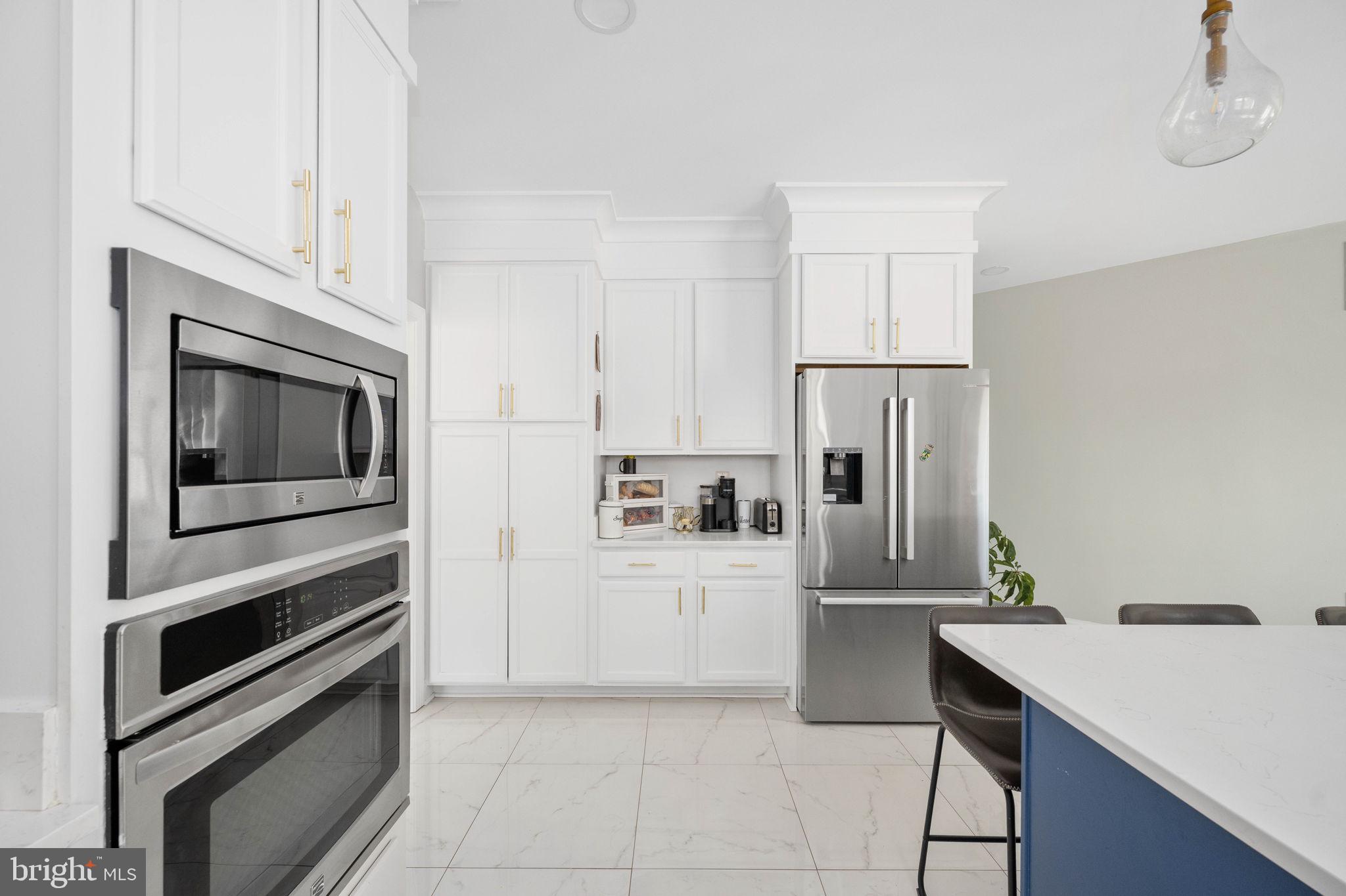 9590 Blackbird Loop Culpeper, VA 22701 - Photo 38 of 76 a kitchen with stainless steel appliances a refrigerator microwave and stove