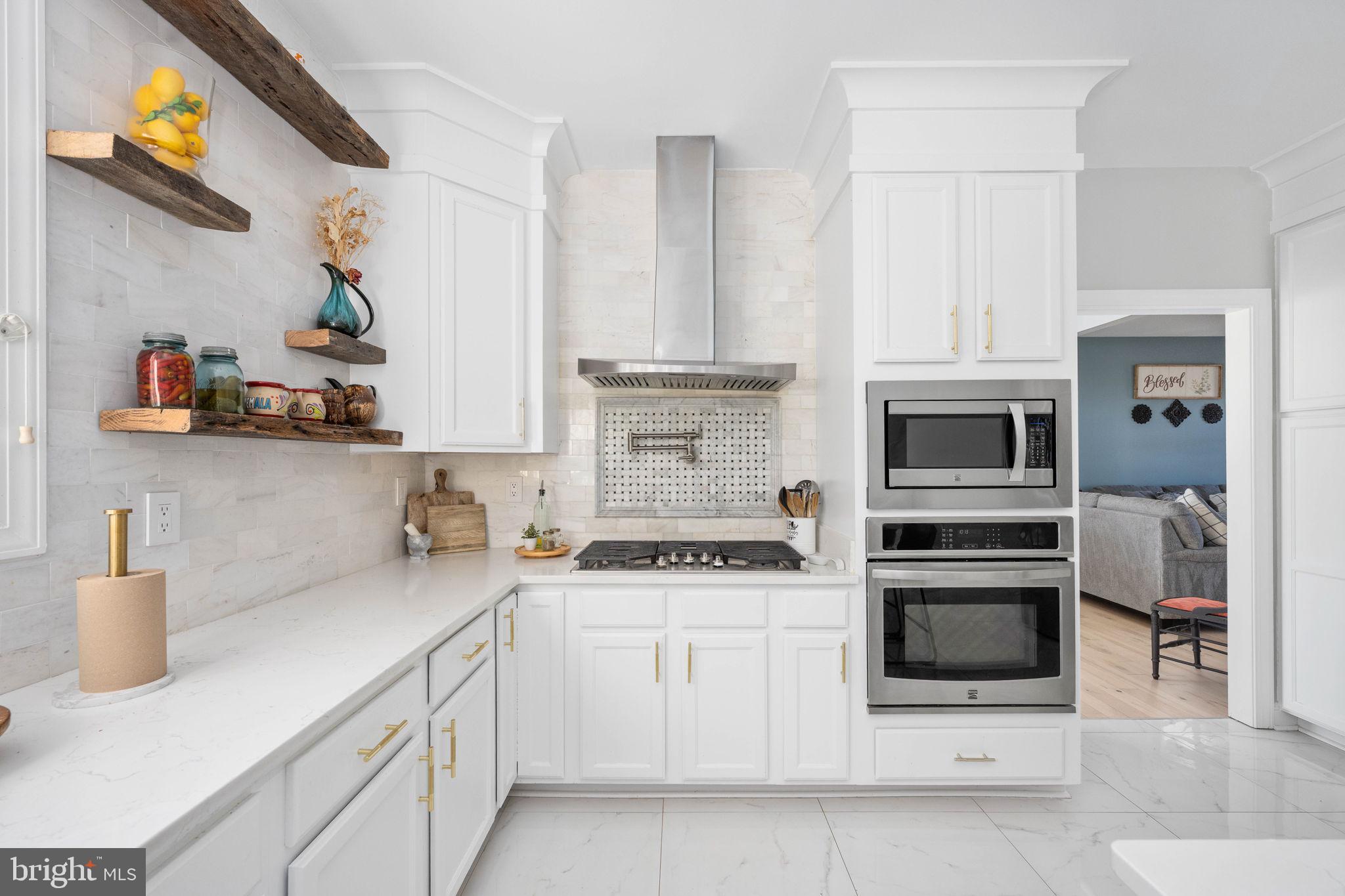 9590 Blackbird Loop Culpeper, VA 22701 - Photo 40 of 76 a kitchen with stainless steel appliances granite countertop a stove and white cabinets