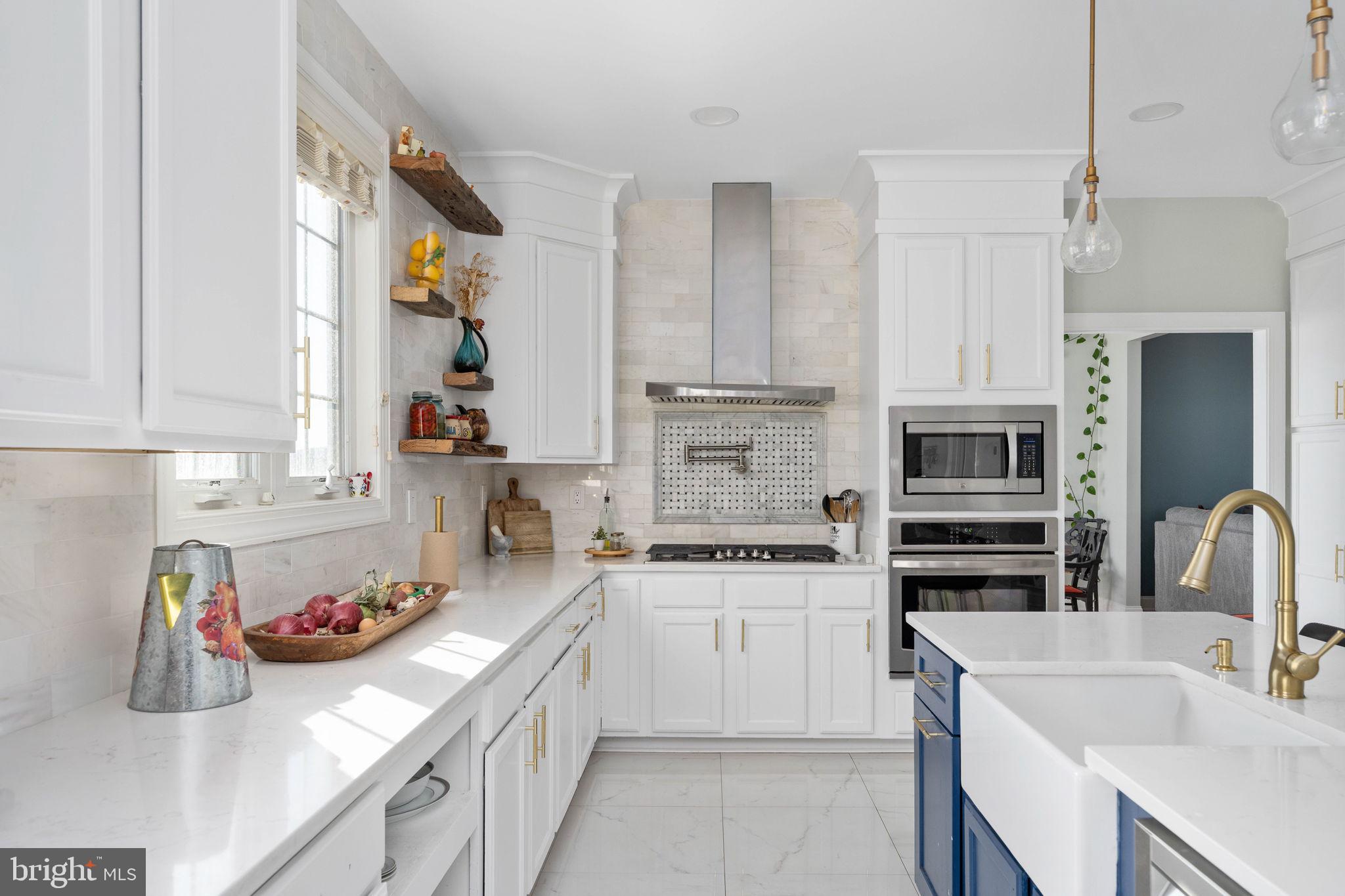 9590 Blackbird Loop Culpeper, VA 22701 - Photo 41 of 76 a kitchen with a sink dishwasher stove and white cabinets with wooden floor