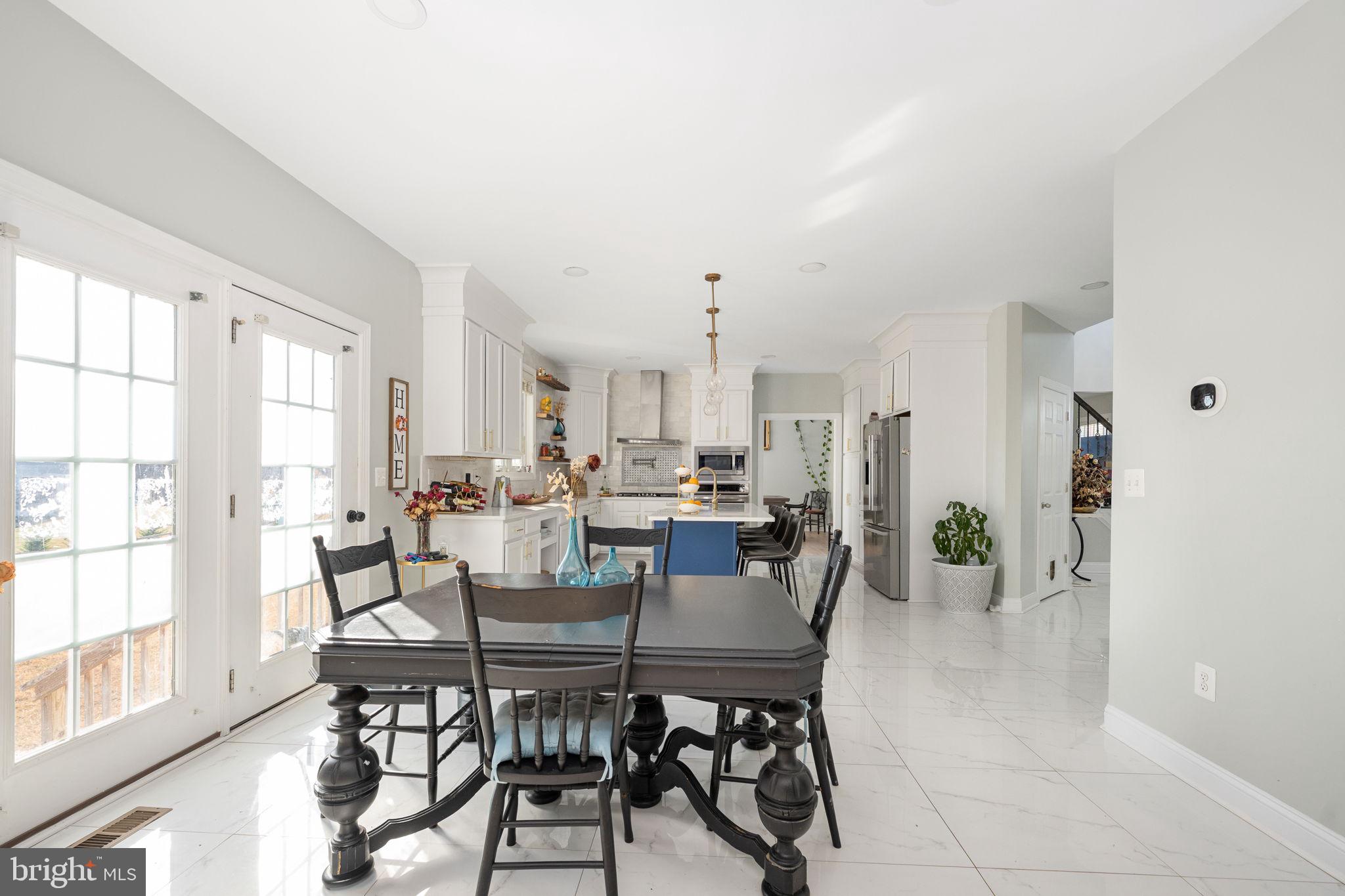9590 Blackbird Loop Culpeper, VA 22701 - Photo 46 of 76 a view of a dining room with furniture and a potted plant