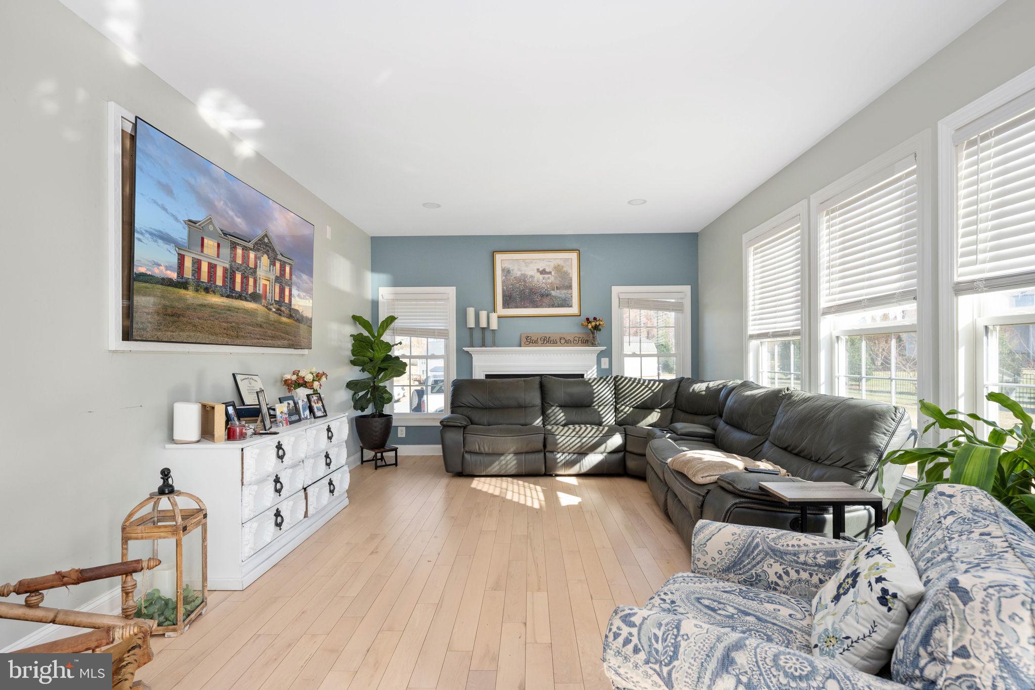 9590 Blackbird Loop Culpeper, VA 22701 - Photo 52 of 76 a living room with furniture wooden floor and a large window