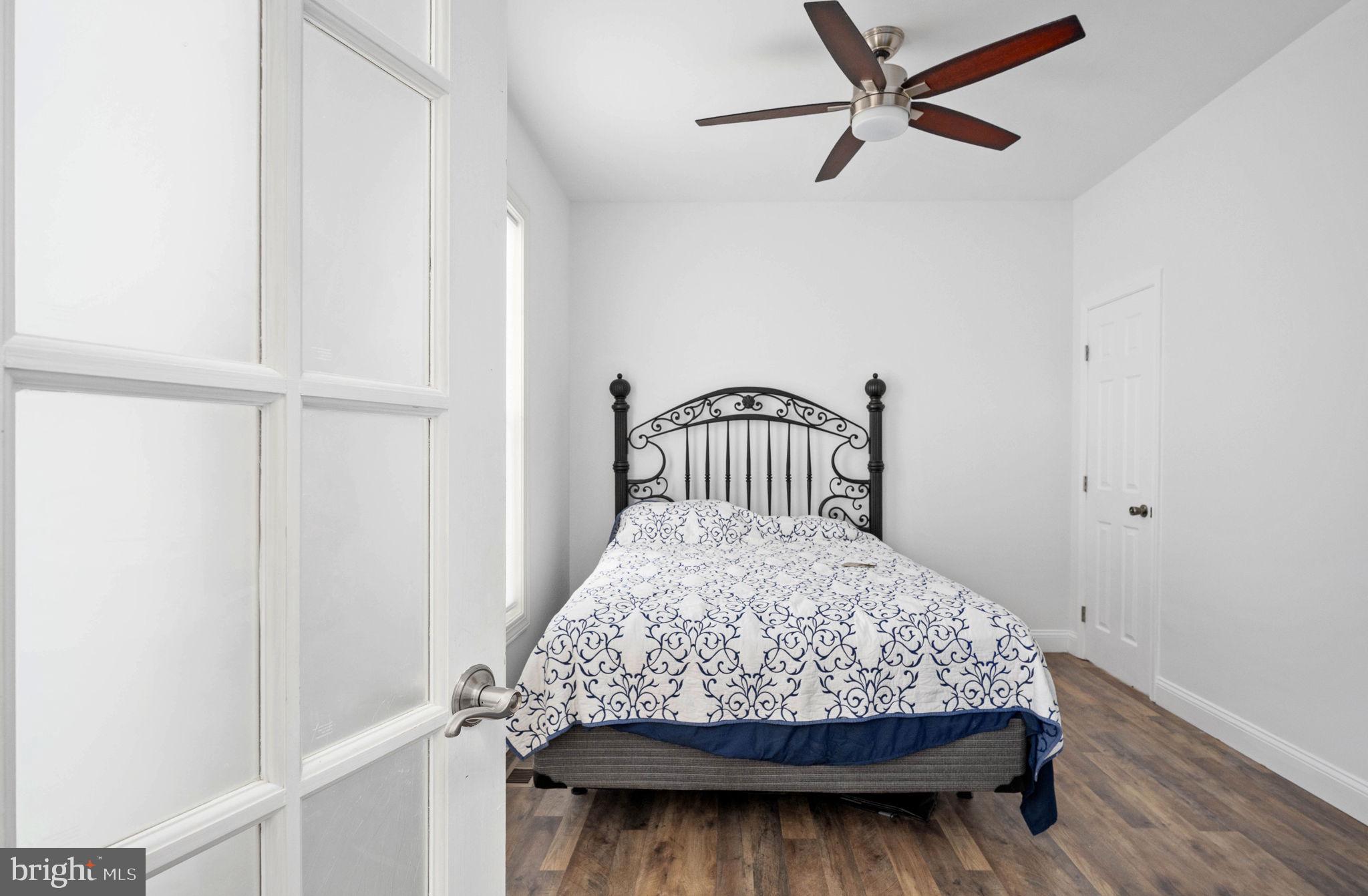 9590 Blackbird Loop Culpeper, VA 22701 - Photo 55 of 76 a bedroom with a bed window and a ceiling fan
