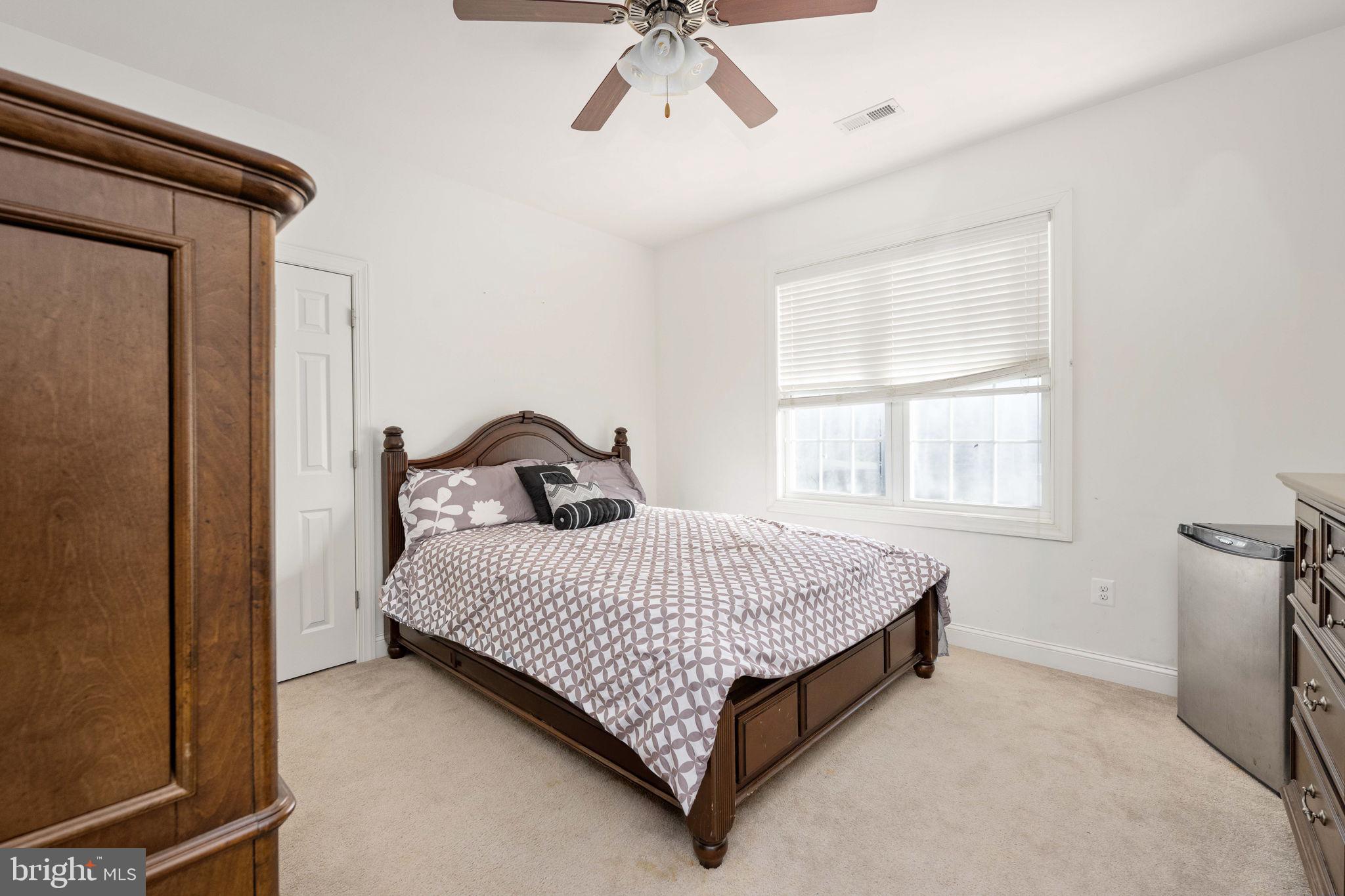 9590 Blackbird Loop Culpeper, VA 22701 - Photo 64 of 76 a bed sitting in a bedroom next to a window
