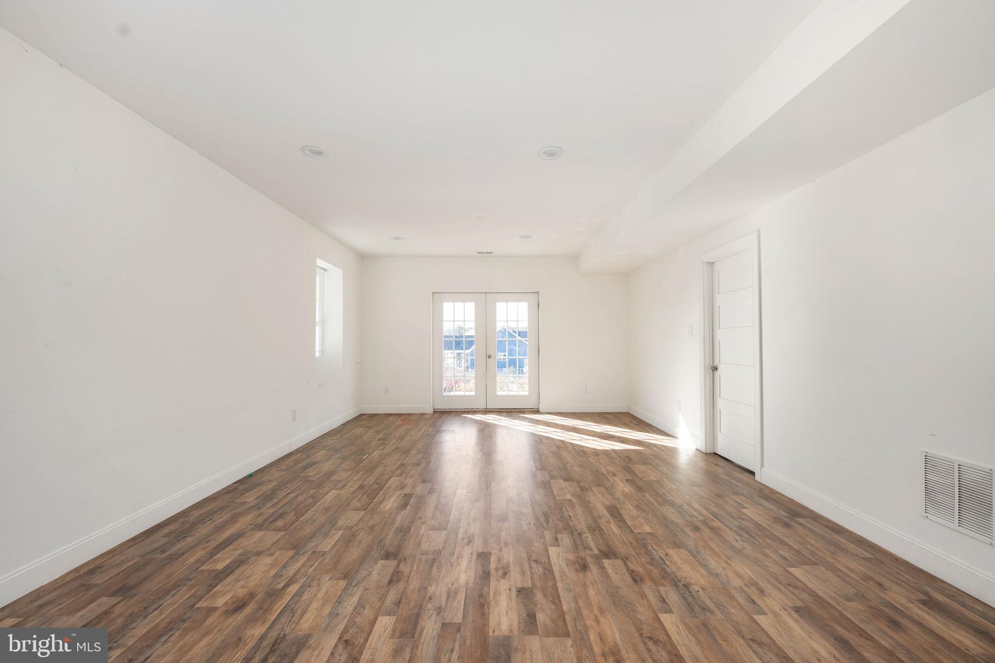 9590 Blackbird Loop Culpeper, VA 22701 - Photo 67 of 76 a view of an empty room with wooden floor and a window