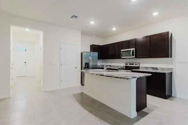 a stove top oven sitting inside of a kitchen