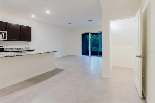 a bathroom with a granite countertop sink and a toilet
