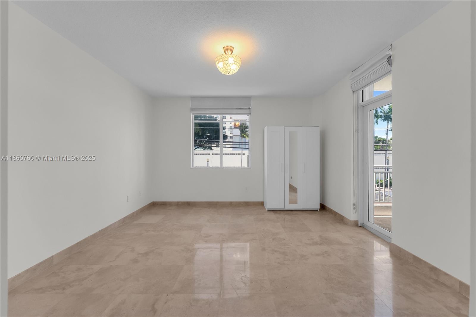 1 Century Lane, Unit 202 Miami Beach, FL 33139 - Photo 14 of 28 an empty room with windows and closet
